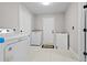Spacious laundry room with white washer, dryer and tile floor at 556 Johns Pass Ave, Madeira Beach, FL 33708