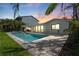 Inviting pool and spa area with an outdoor kitchen, perfect for entertaining at twilight at 556 Johns Pass Ave, Madeira Beach, FL 33708