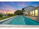 Lovely pool and spa with outdoor kitchen and vibrant sunset views over the waterfront property at 556 Johns Pass Ave, Madeira Beach, FL 33708