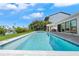 Backyard pool with built-in spa, outdoor kitchen, and large patio area at 556 Johns Pass Ave, Madeira Beach, FL 33708