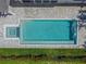 Aerial view of a modern pool with a spa, paver deck and beautiful landscaping at 556 Johns Pass Ave, Madeira Beach, FL 33708