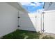 Side yard view of white fence gate at 556 Johns Pass Ave, Madeira Beach, FL 33708