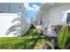 Green side yard with stepping stones between white fence and white house at 556 Johns Pass Ave, Madeira Beach, FL 33708