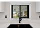 A black faucet over a sink is framed by a window with a view of the outdoors at 556 Johns Pass Ave, Madeira Beach, FL 33708