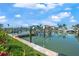 Picturesque waterfront view with boat docks and lush landscaping on a sunny day at 556 Johns Pass Ave, Madeira Beach, FL 33708
