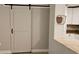 Stylish sliding barn door adding character and charm to the living space at 5725 80Th N St # 107, St Petersburg, FL 33709