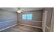 Cozy bedroom with new wood flooring, ceiling fan, and window with blind at 5725 80Th N St # 107, St Petersburg, FL 33709