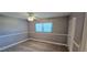 Cozy bedroom with new wood flooring, ceiling fan, and window with blind at 5725 80Th N St # 107, St Petersburg, FL 33709