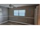 Neutral bedroom featuring wood-look floors, chair railing, and ample natural light at 5725 80Th N St # 107, St Petersburg, FL 33709