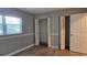Bedroom featuring new wood flooring, ample closet space, and a bright window at 5725 80Th N St # 107, St Petersburg, FL 33709