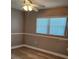 Neutral bedroom featuring wood-look floors, chair railing, and ample natural light at 5725 80Th N St # 107, St Petersburg, FL 33709