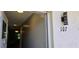 Welcoming entrance featuring unit number and light fixture, leading into a bright interior at 5725 80Th N St # 107, St Petersburg, FL 33709