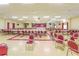 Large event hall with tables, chairs, and a stage, ideal for gatherings at 5725 80Th N St # 107, St Petersburg, FL 33709
