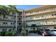 Multi-level condo building with palm trees, updated facade, and well-maintained landscaping at 5725 80Th N St # 107, St Petersburg, FL 33709