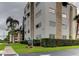 Modern condo building with white exterior and stone accents, set on a landscaped lot at 5725 80Th N St # 107, St Petersburg, FL 33709