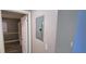 Hallway featuring a white door, access to electrical panel, and neutral color palette at 5725 80Th N St # 107, St Petersburg, FL 33709