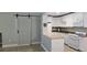 Bright kitchen with white cabinets, breakfast bar, gas range, and tile backsplash at 5725 80Th N St # 107, St Petersburg, FL 33709