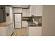 Modern kitchen with white cabinets, stainless appliances, and granite counters, offering a functional design at 5725 80Th N St # 107, St Petersburg, FL 33709
