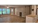 Open-concept living room with tile flooring, natural light, and a sliding barn door feature at 5725 80Th N St # 107, St Petersburg, FL 33709