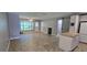 Open living area with tile flooring, kitchen with island, and natural light from back patio at 5725 80Th N St # 107, St Petersburg, FL 33709
