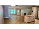 Bright living area with tile flooring, kitchen, fan, and sliding glass doors to outdoor area at 5725 80Th N St # 107, St Petersburg, FL 33709