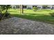 View of the brick patio and grassy yard at 5725 80Th N St # 107, St Petersburg, FL 33709