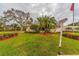 Landscaped corner lot with a bus stop sign and lush greenery at 5725 80Th N St # 107, St Petersburg, FL 33709