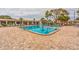 Sparkling community swimming pool with lounge chairs and landscaped surroundings at 5725 80Th N St # 107, St Petersburg, FL 33709