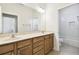 Bathroom featuring dual sinks, granite countertops, wood cabinets, and tile flooring at 601 Viento De Avila, Tampa, FL 33613