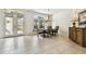 Elegant dining room with tiled floors, large windows, and a stylish chandelier at 601 Viento De Avila, Tampa, FL 33613