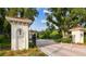 Gated community entrance features lush landscaping and mature trees at 601 Viento De Avila, Tampa, FL 33613