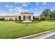 Beautiful home exterior showcases a manicured lawn, fountain, and a circular flowerbed at 601 Viento De Avila, Tampa, FL 33613
