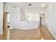 Open hallway with wood floors, white walls, and access to multiple rooms at 601 Viento De Avila, Tampa, FL 33613
