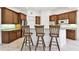 Kitchen with wooden cabinets, granite countertops, and a breakfast bar with three stools at 601 Viento De Avila, Tampa, FL 33613