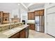 Bright kitchen boasts granite counters, stainless steel appliances, and wood cabinets at 601 Viento De Avila, Tampa, FL 33613