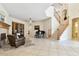 Open living space with fireplace, staircase, piano, and wooden floor accents at 601 Viento De Avila, Tampa, FL 33613