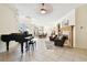 Spacious living room featuring a fireplace, grand piano, and open access to the dining area at 601 Viento De Avila, Tampa, FL 33613