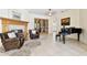 Inviting living room with a fireplace, leather chairs, and a black grand piano at 601 Viento De Avila, Tampa, FL 33613