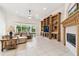 Comfortable living room with a fireplace, built-in shelving, and a large window at 601 Viento De Avila, Tampa, FL 33613