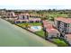 Aerial view showcasing waterfront condos, lush landscaping, and a serene swimming pool at 6140 Sun Blvd # 7, St Petersburg, FL 33715