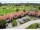 Aerial view of townhomes near golf course, showcasing lush landscaping and community parking areas at 6140 Sun Blvd # 7, St Petersburg, FL 33715