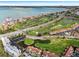 Aerial view showcases a golf course community with waterfront condos, a marina and cityscape in the distance at 6140 Sun Blvd # 7, St Petersburg, FL 33715