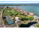 Breathtaking aerial view of a golf course, tennis courts, and waterfront condominiums at 6140 Sun Blvd # 7, St Petersburg, FL 33715