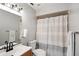 Clean bathroom featuring a modern vanity, toilet, and a shower with a gray and white curtain at 6140 Sun Blvd # 7, St Petersburg, FL 33715