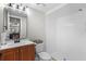 Bathroom features a vanity, toilet, mirror, and walk-in shower with white tiled walls at 6140 Sun Blvd # 7, St Petersburg, FL 33715