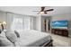 Bright bedroom featuring a ceiling fan, walk-in closet, and large window for plenty of natural light at 6140 Sun Blvd # 7, St Petersburg, FL 33715