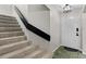 Inviting entryway with tiled floor and carpeted stairs and black railing at 6140 Sun Blvd # 7, St Petersburg, FL 33715