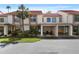 Townhome exterior with a front yard, driveway, and carports for parking at 6140 Sun Blvd # 7, St Petersburg, FL 33715