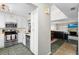 View of kitchen features white cabinets, stainless steel appliances, and a seamless view into the dining area at 6140 Sun Blvd # 7, St Petersburg, FL 33715