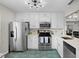 Clean kitchen featuring stainless steel appliances, white cabinets, and modern lighting at 6140 Sun Blvd # 7, St Petersburg, FL 33715
